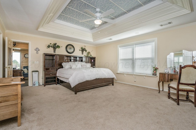 carpeted bedroom with a raised ceiling, ceiling fan, and crown molding