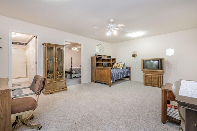 bedroom with carpet flooring, ceiling fan, and ensuite bath