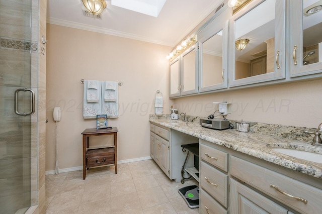 bathroom with vanity, a skylight, a shower with door, and ornamental molding
