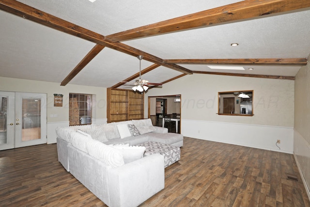 living room with visible vents, wood finished floors, vaulted ceiling with beams, a wainscoted wall, and french doors