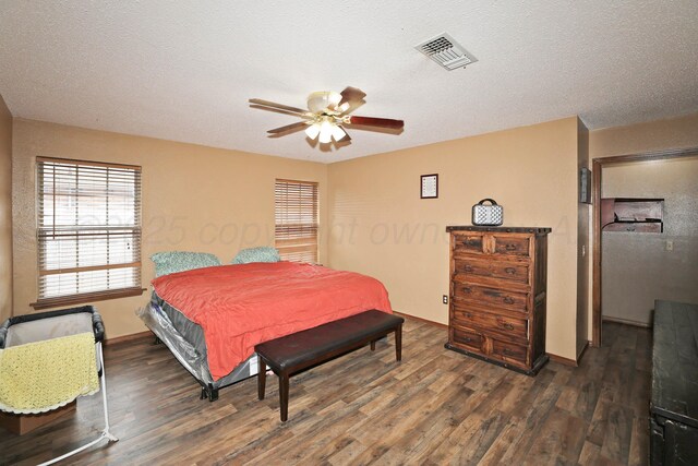 1005 Bennett Dr, Dumas, TX 79029 - bedroom featuring wood finished floors, baseboards, a ceiling fan, and a textured ceiling