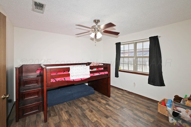 1005 Bennett Dr, Dumas, TX 79029 - bedroom featuring wood finished floors, a textured ceiling, and ceiling fan