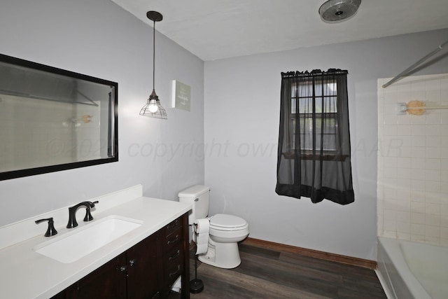 full bathroom with vanity, toilet, baseboards, tub / shower combination, and wood finished floors