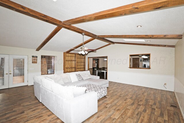 1005 Bennett Dr, Dumas, TX 79029 - living area with french doors, wood finished floors, wainscoting, and ceiling fan