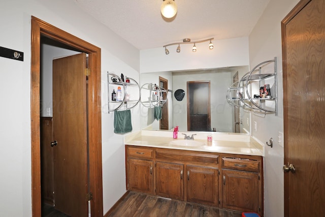 bathroom featuring a textured ceiling, wood finished floors, and vanity