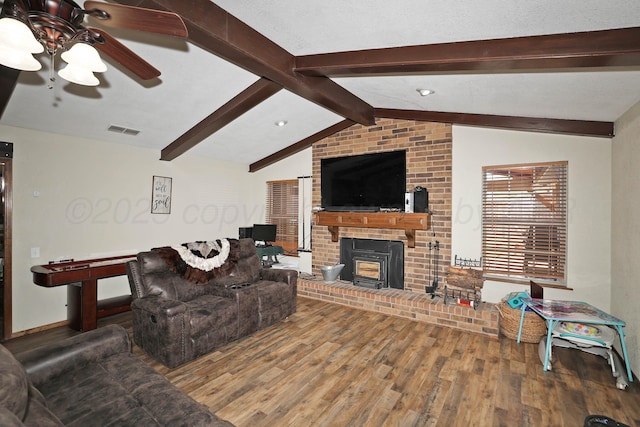 living area featuring ceiling fan, lofted ceiling with beams, baseboards, wood finished floors, and visible vents