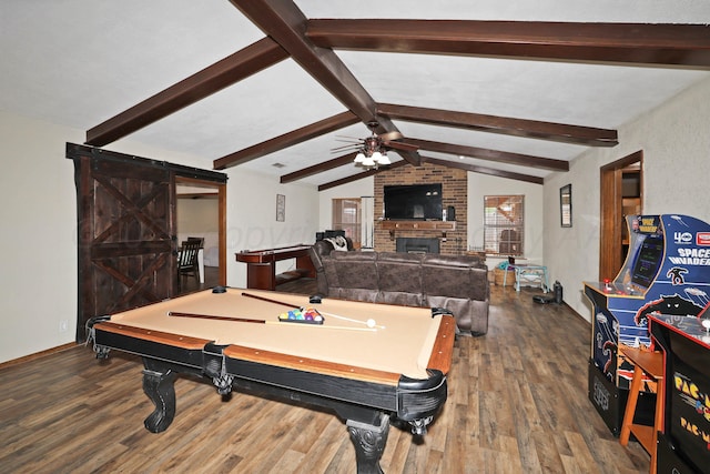 rec room featuring a brick fireplace, a ceiling fan, billiards, vaulted ceiling with beams, and wood finished floors