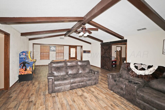1005 Bennett Dr, Dumas, TX 79029 - living area with a barn door, wood finished floors, and ceiling fan