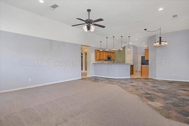 unfurnished living room with vaulted ceiling, ceiling fan with notable chandelier, and a textured ceiling