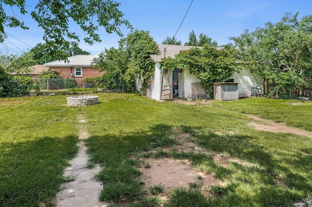 300 E 4th St, Clarendon, TX 79226 - view of yard featuring an outdoor fire pit