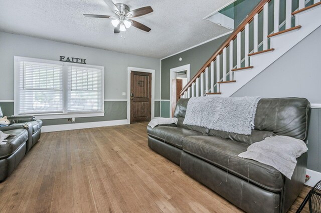 300 E 4th St, Clarendon, TX 79226 - living room featuring a ceiling fan, a textured ceiling, stairs, and wood finished floors