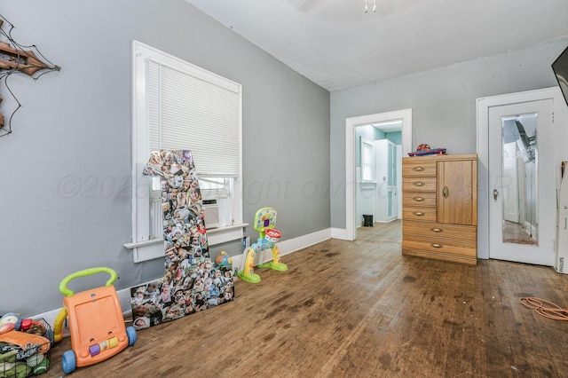 300 E 4th St, Clarendon, TX 79226 - recreation room with wood finished floors, a ceiling fan, and baseboards