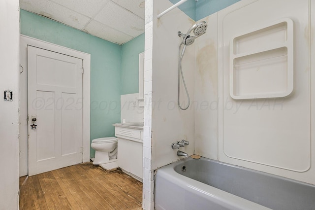 300 E 4th St, Clarendon, TX 79226 - full bath with a drop ceiling, hardwood / wood-style flooring, washtub / shower combination, toilet, and vanity