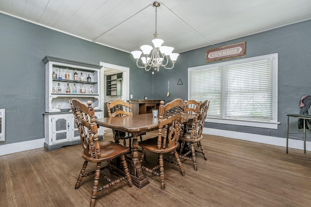 300 E 4th St, Clarendon, TX 79226 - dining area with wood finished floors, a chandelier, baseboards, and wooden ceiling