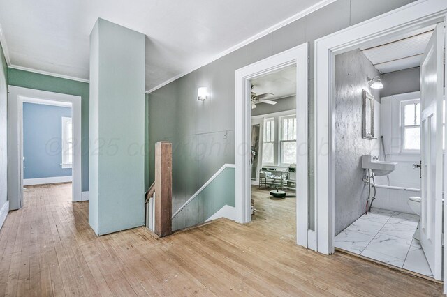 300 E 4th St, Clarendon, TX 79226 - hall featuring an upstairs landing, crown molding, plenty of natural light, and light wood-style flooring