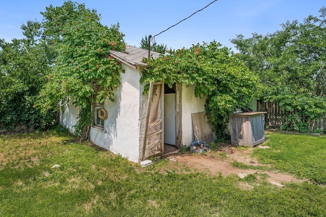 300 E 4th St, Clarendon, TX 79226 - view of side of property featuring stucco siding and an outbuilding