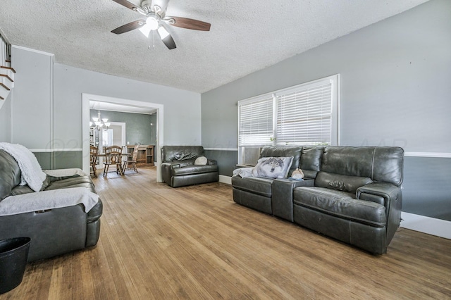 300 E 4th St, Clarendon, TX 79226 - living area featuring a textured ceiling, a ceiling fan, wood finished floors, and a chandelier