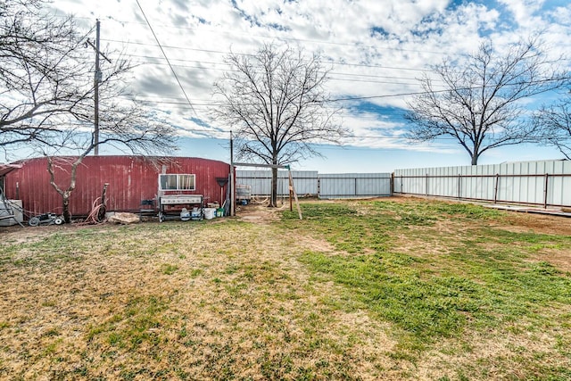 view of yard with an outbuilding and fence