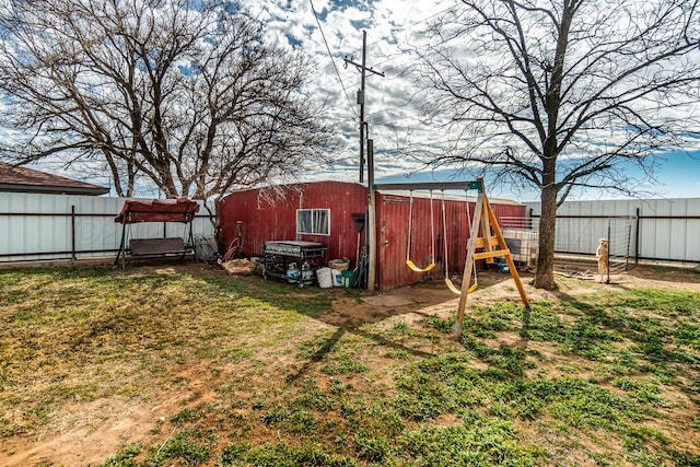 view of yard featuring fence and an outbuilding