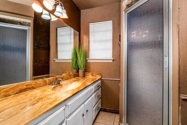 full bathroom with wainscoting, a shower stall, vanity, and tile patterned floors