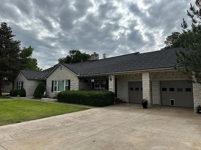 ranch-style home with a front yard and a garage