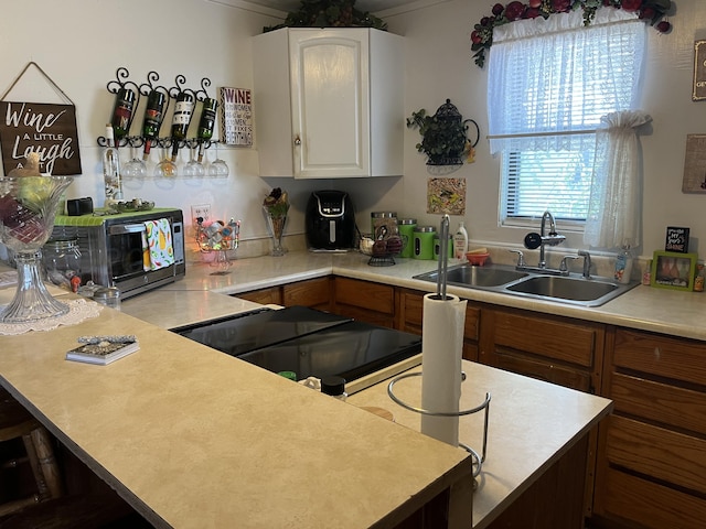 kitchen featuring white cabinetry and sink