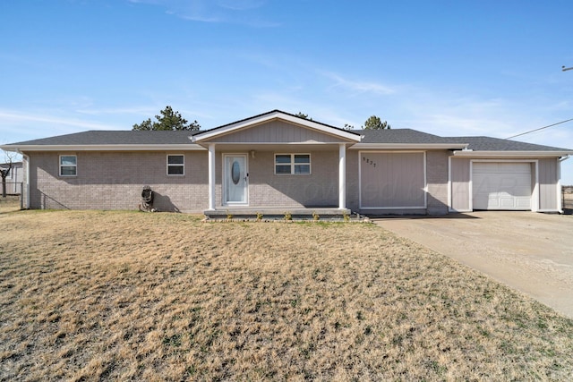 ranch-style house with covered porch, a garage, and a front lawn