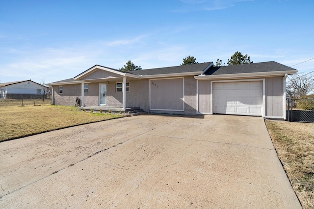 single story home featuring a front lawn and a garage