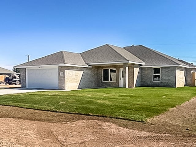 view of front of house featuring a front lawn and a garage