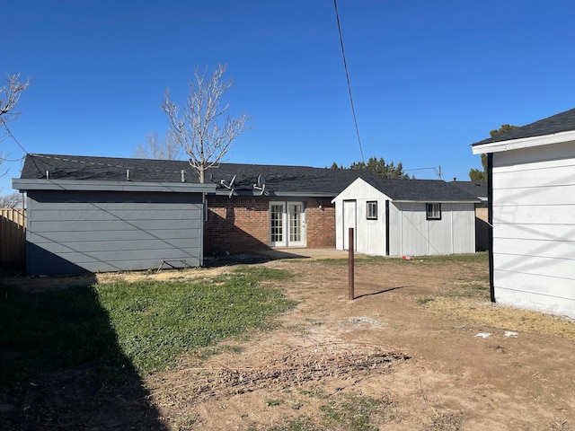 back of house with french doors and an outdoor structure