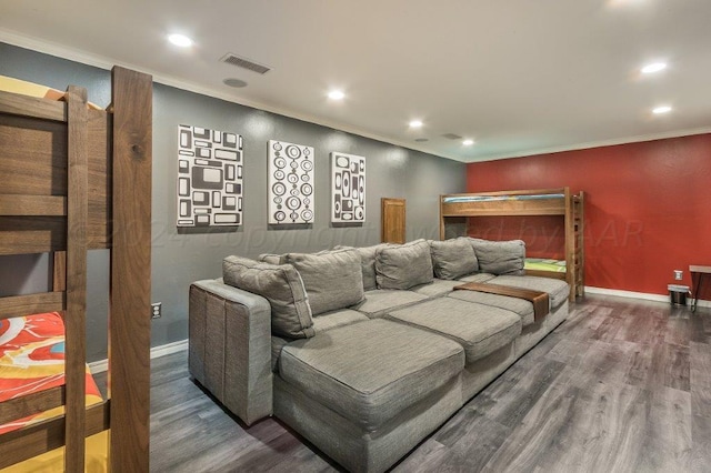 cinema room featuring ornamental molding and dark hardwood / wood-style floors