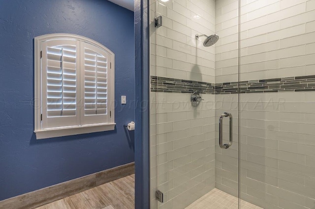 bathroom featuring walk in shower and hardwood / wood-style floors