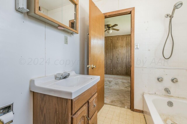 bathroom featuring wood walls, vanity, and ceiling fan