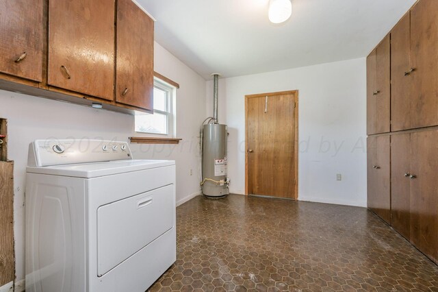 laundry area featuring cabinets, gas water heater, and washer / dryer