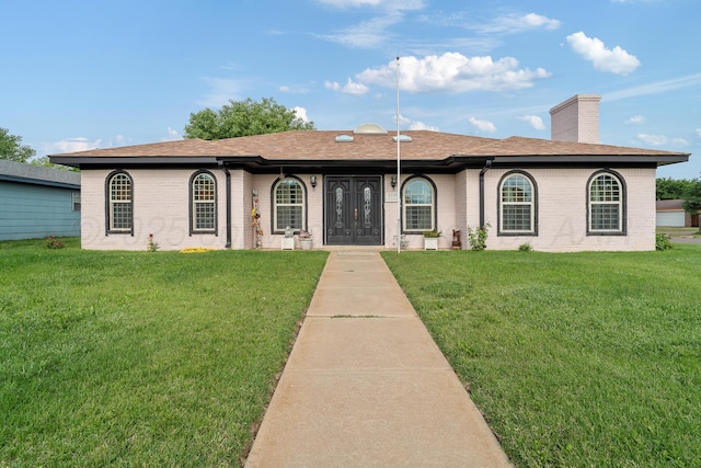3100 Pittsburg St, Amarillo, TX 79103 - ranch-style home featuring brick siding, a chimney, a front yard, and roof with shingles
