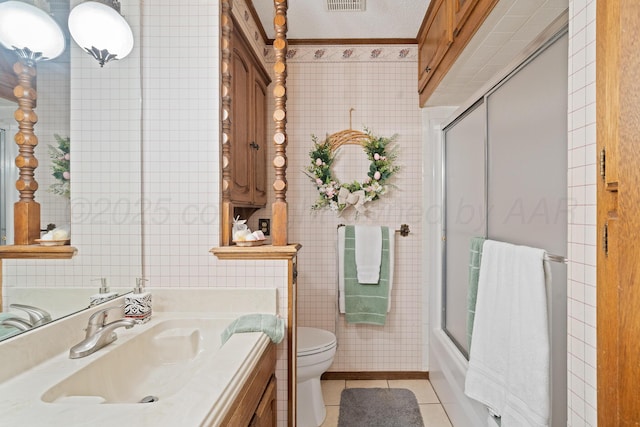 3100 Pittsburg St, Amarillo, TX 79103 - full bathroom featuring toilet, vanity, tile walls, tile patterned flooring, and ornamental molding