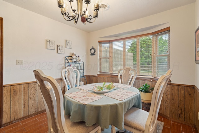 3100 Pittsburg St, Amarillo, TX 79103 - dining space featuring a wainscoted wall, wooden walls, wood finished floors, and a chandelier
