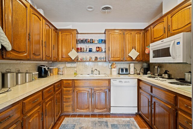 3100 Pittsburg St, Amarillo, TX 79103 - kitchen featuring white appliances, a sink, backsplash, and light countertops