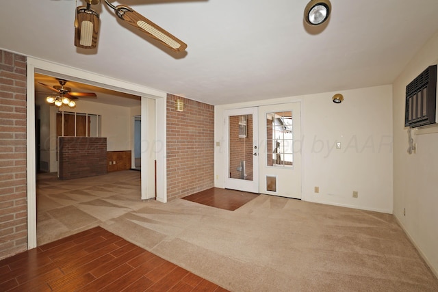 entrance foyer featuring ceiling fan, french doors, wood finished floors, carpet flooring, and baseboards