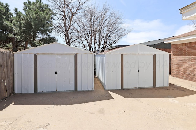 view of shed featuring fence