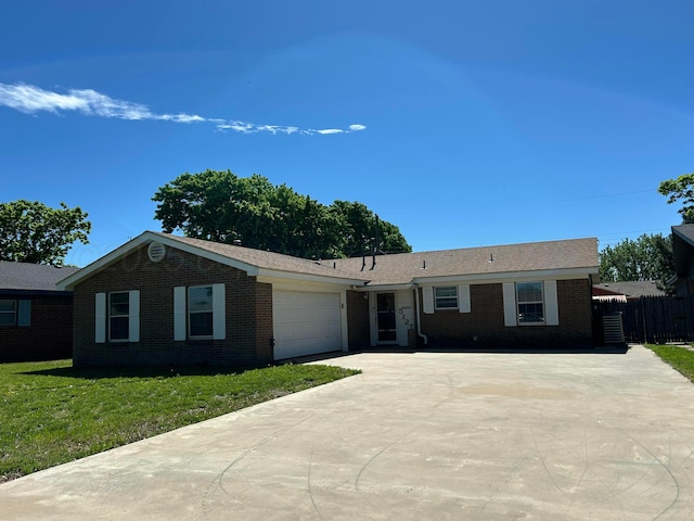 ranch-style house featuring brick siding, driveway, and an attached garage