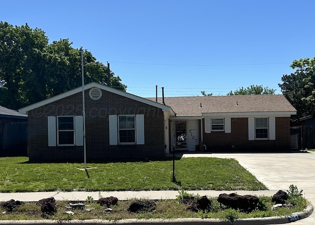 ranch-style house with brick siding and a front yard