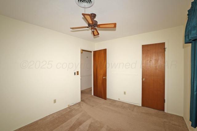 unfurnished bedroom with light carpet and ceiling fan