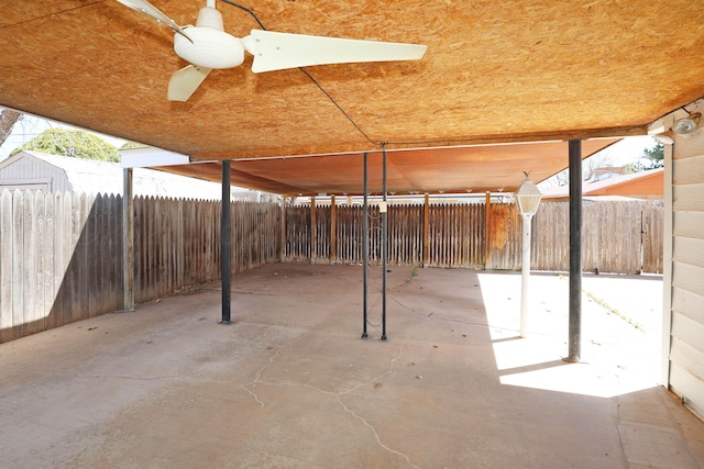 view of patio / terrace with a storage shed, a fenced backyard, and an outdoor structure