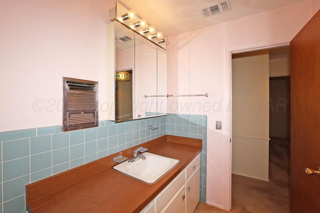 bathroom featuring radiator, tasteful backsplash, and vanity