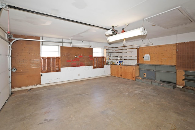 garage featuring a garage door opener and a workshop area