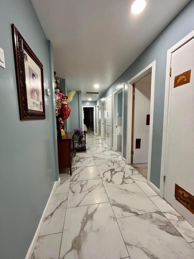 corridor with recessed lighting, baseboards, and marble finish floor