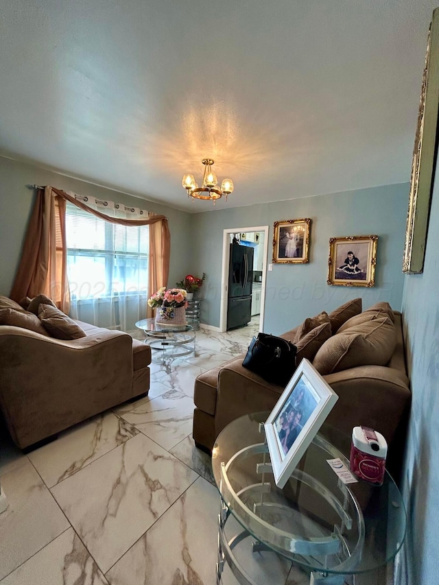 living room featuring marble finish floor and a chandelier