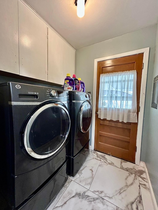 washroom with baseboards, marble finish floor, cabinet space, and washing machine and clothes dryer