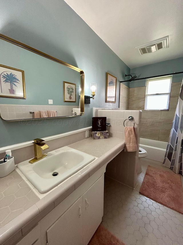 bathroom featuring visible vents, vanity, toilet, shower / bathtub combination with curtain, and tile patterned floors